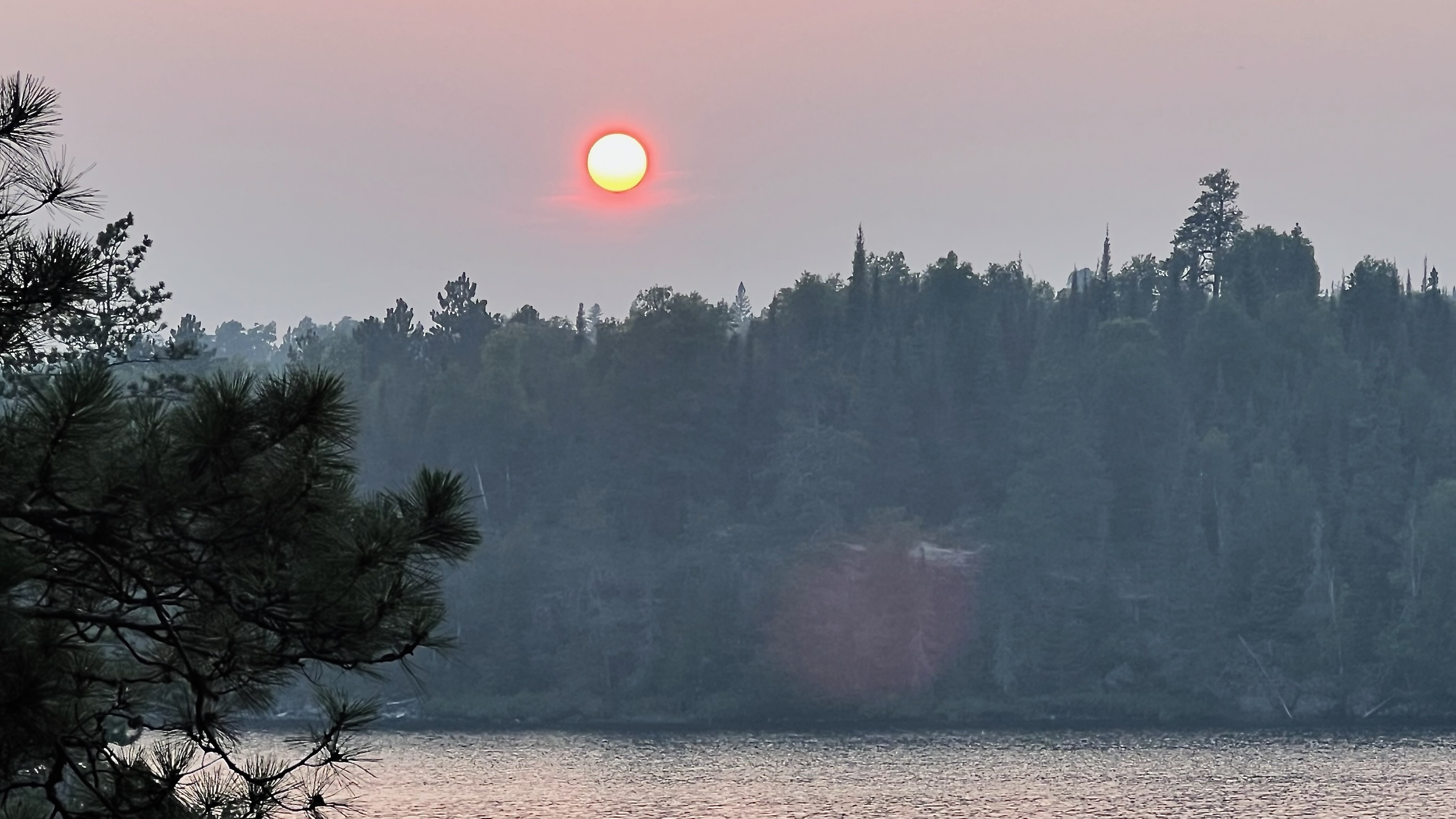 Sun setting through smoke on Saganagons Lake 2025-08-11 19:54